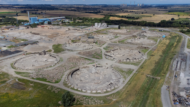 The base of the eight cooling towers in the wake of the demolition, the West Burton Power Station's cooling towers can be seen in the far distance